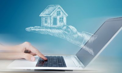 Hand am Laptop mit illustration eines Hauses - Baufinanzierung Erholung Zins-Trend (Foto: Freepik, user33769719)