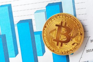 Bitcoin-Münze mit Diagramm im Hintergrund (Foto: Freepik) - Blockchain bietet Investoren mehr Anlagemöglichkeiten als nur Krypto