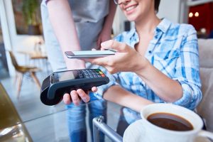 Digitales Bezahlen per Handy in einem Cafe (Foto: freepik, pressfoto) - Schufa: neuer Index misst erstmals Finanzteilhabe der Deutschen