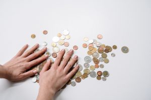 Female hands reaching for coins