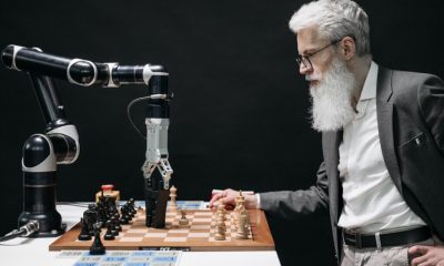 Man playing chess against robot