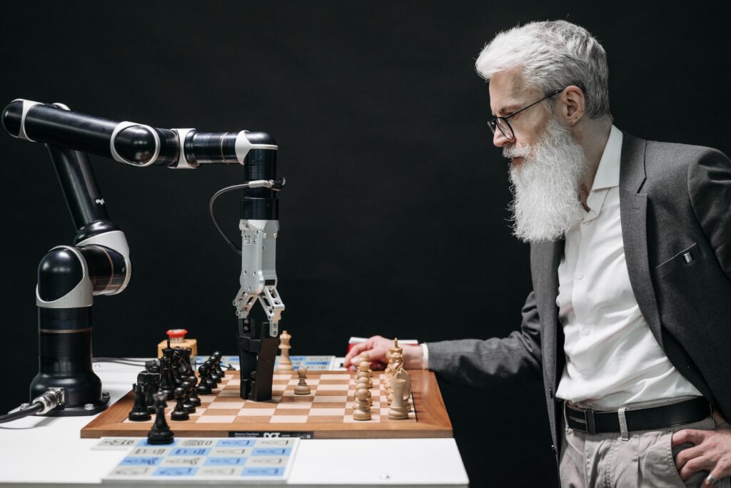 Man playing chess against robot