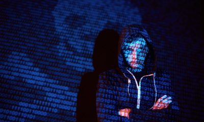 Symbolbild Cyber-Kriminalität mit Hacker und Totenkopf